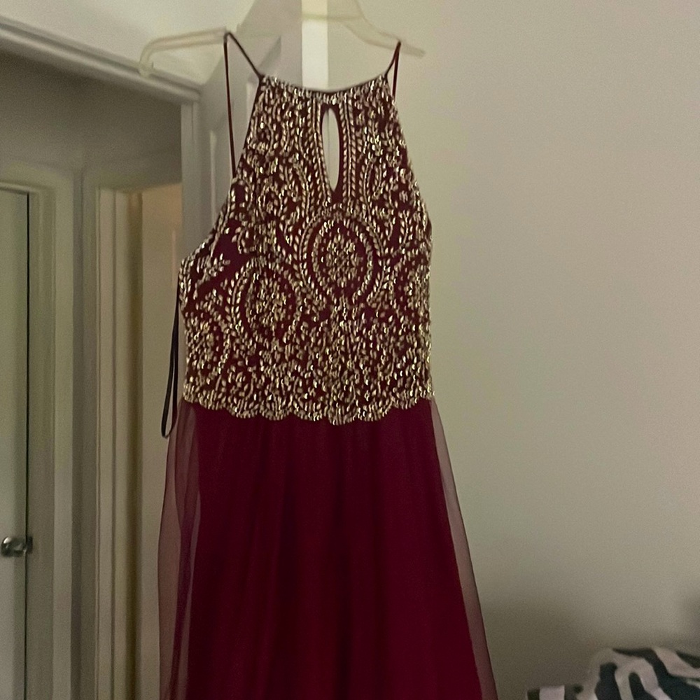 Used once. Burgundy and gold floor length. Has had slight alterations.